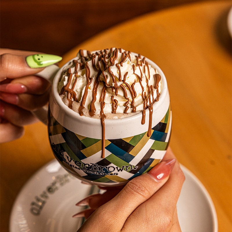 Hot chocolate with cream in an Oliver Brown cup
